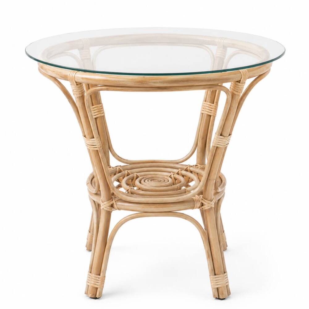 A round natural rattan coffee table with a clear glass tabletop and a woven lower shelf center, isolated on a bright white background.