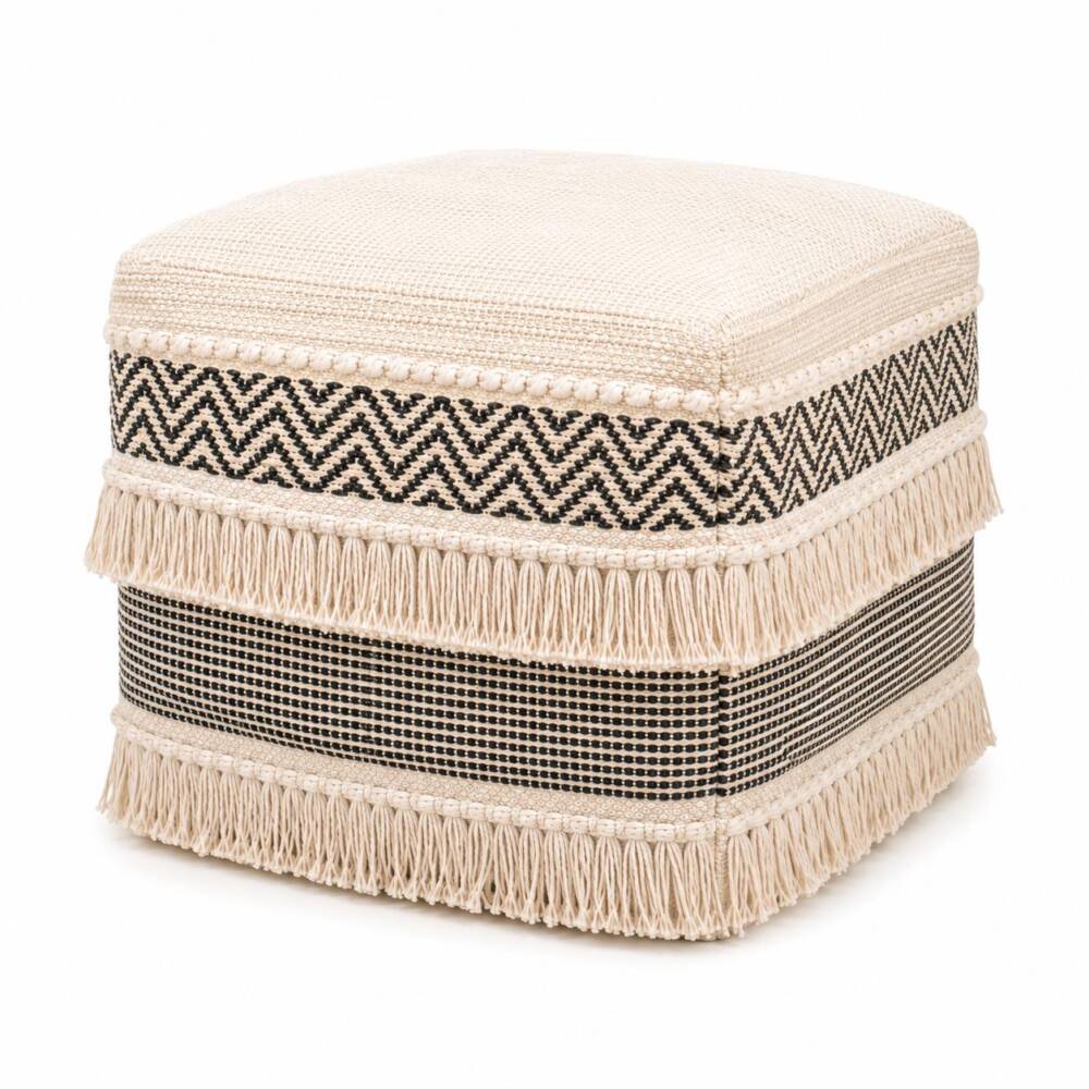 A square cream-colored woven fabric pouf featuring black zig-zag patterns and two rows of decorative hanging fringes.